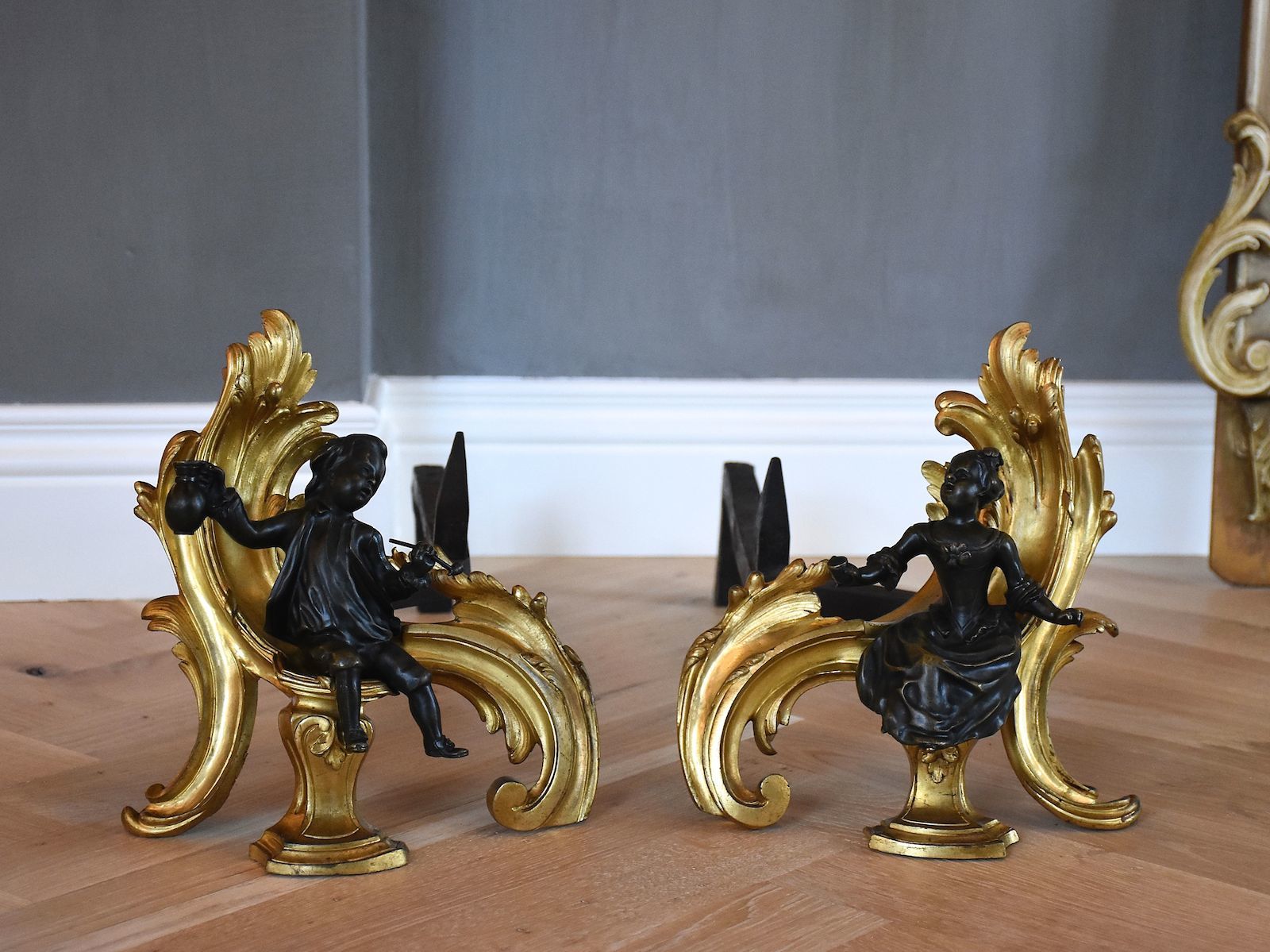 A pair of 19th c. gilt bronze chenets in the style of Louis XV