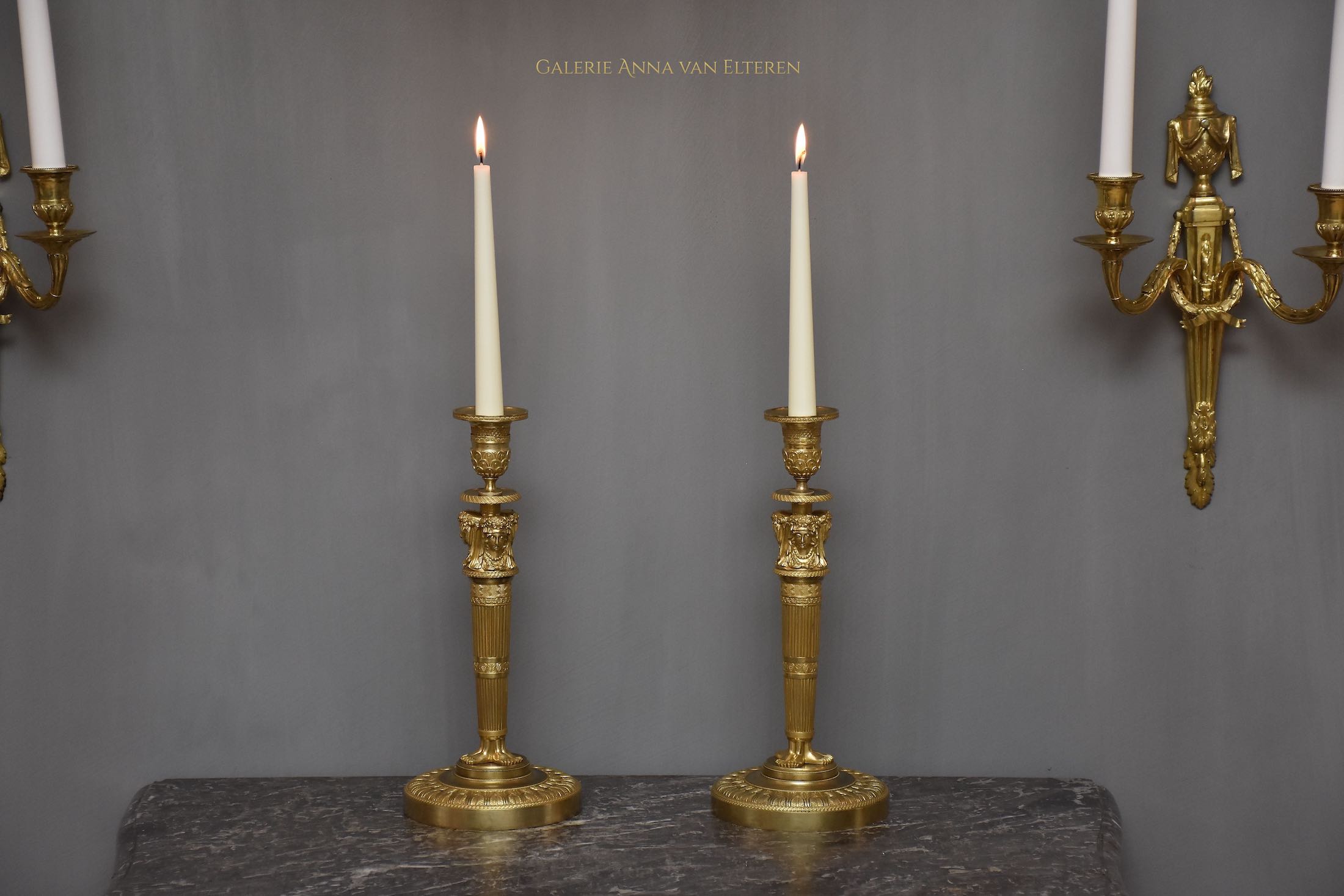 A pair of French Empire ormolu candlesticks