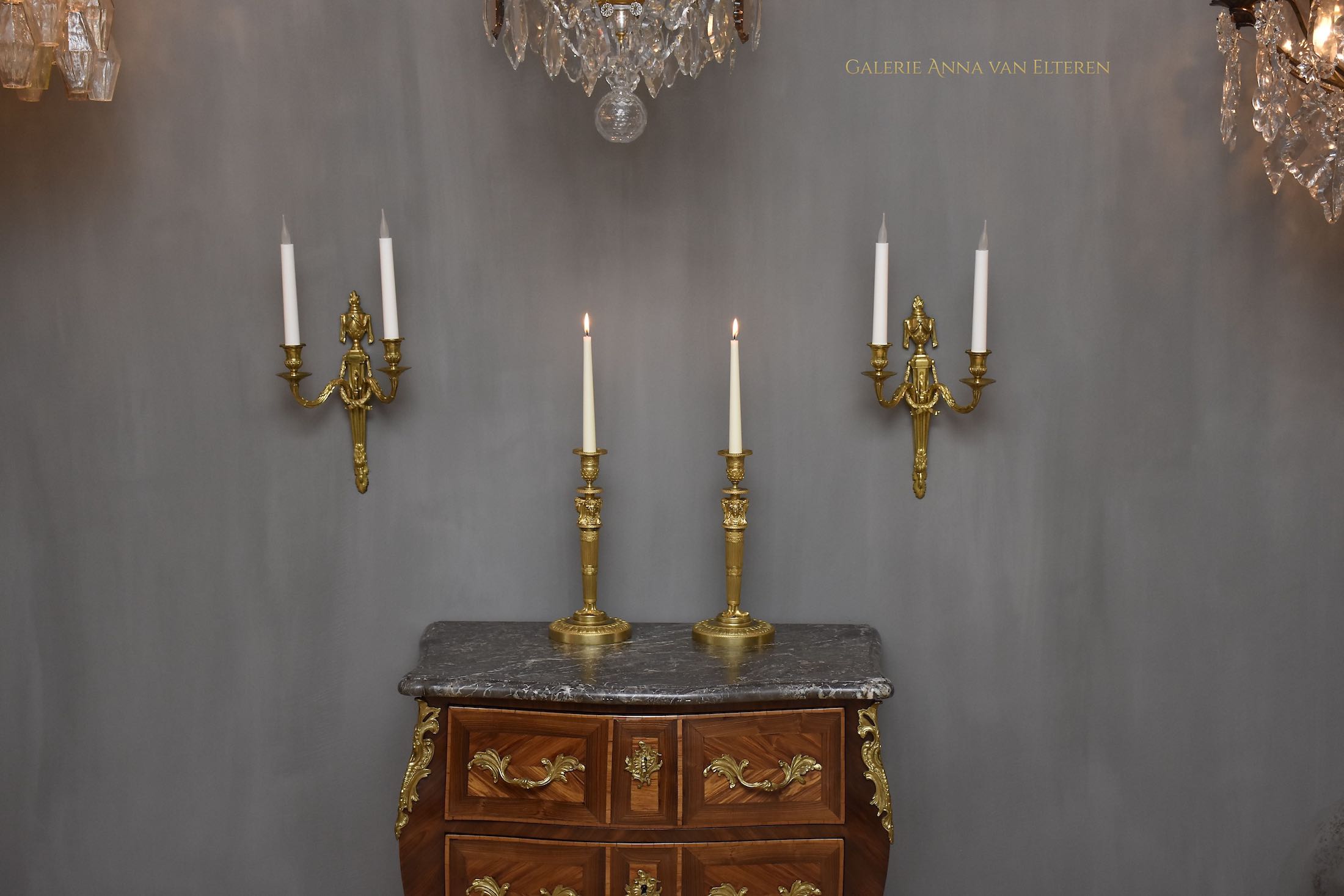 A pair of French Empire ormolu candlesticks