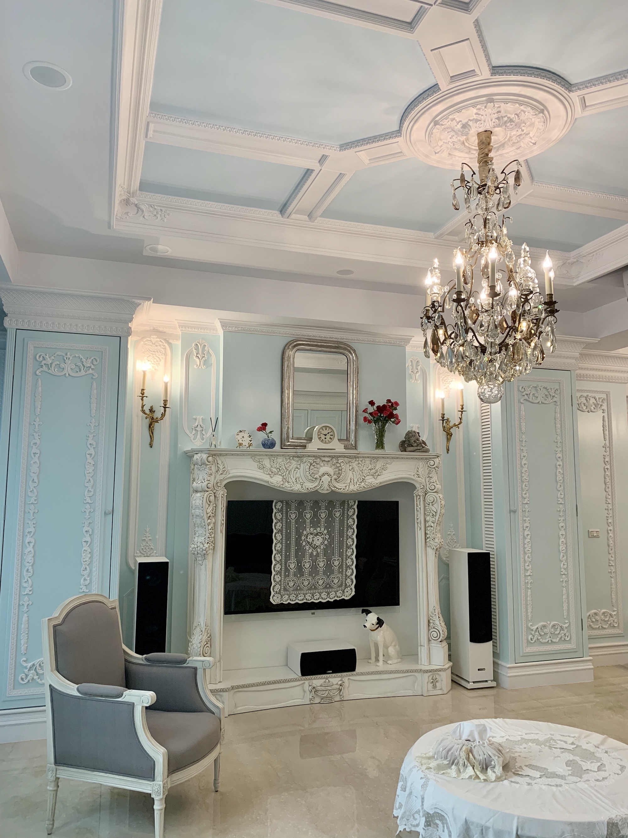 Large French chandelier, antique mirror and Rococo wall lights in the living room